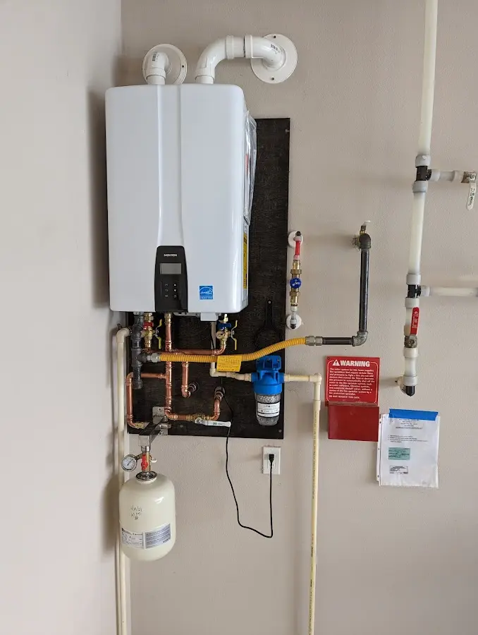 Professional plumber installing copper piping in a Kirkwood home